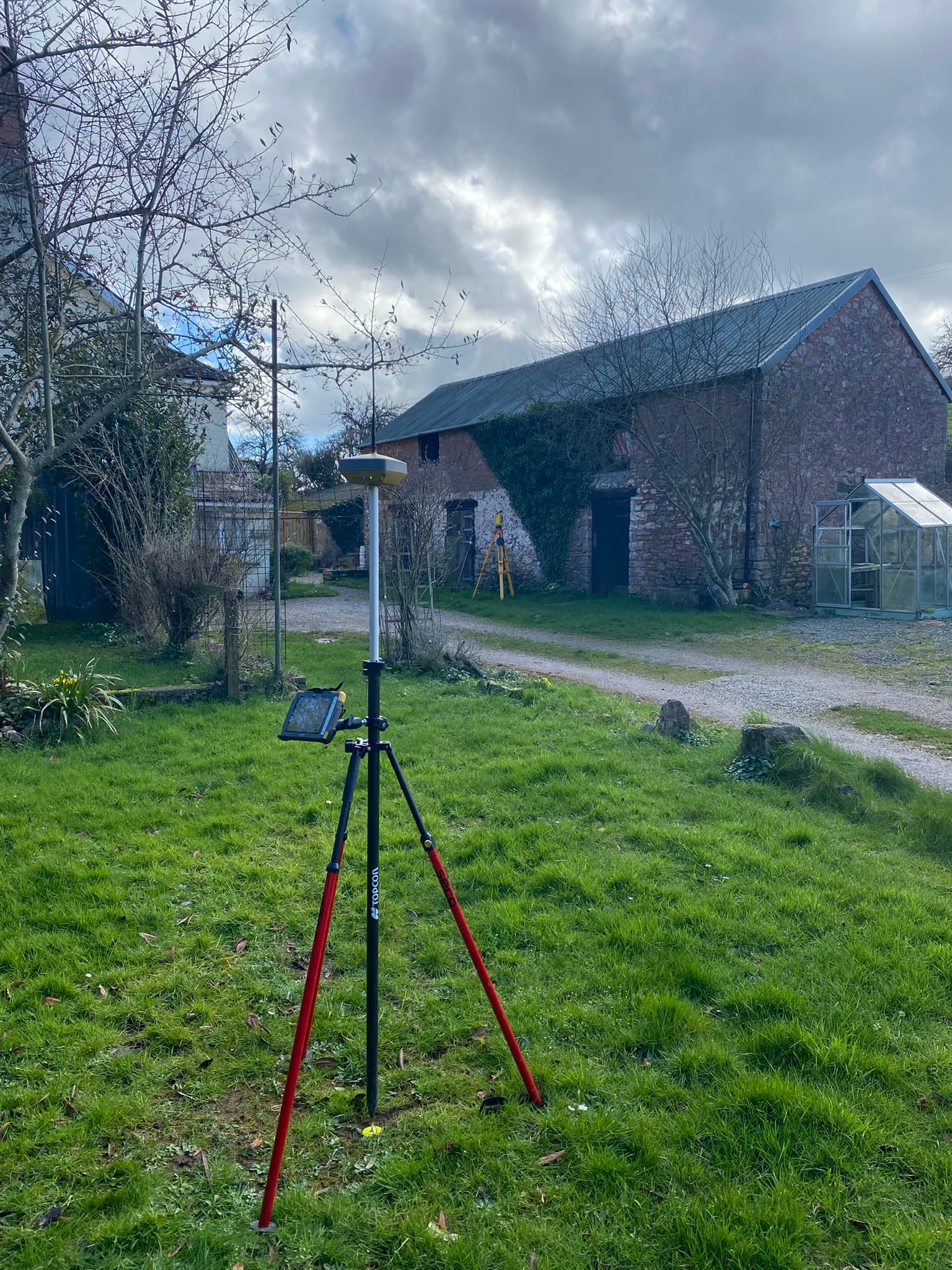 Land surveyor using theodolite in Somerset countryside
